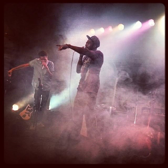 Tripoli performing on stage with a bandmate