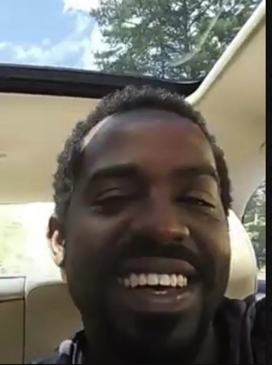 Tripoli smiling in the car during his college years