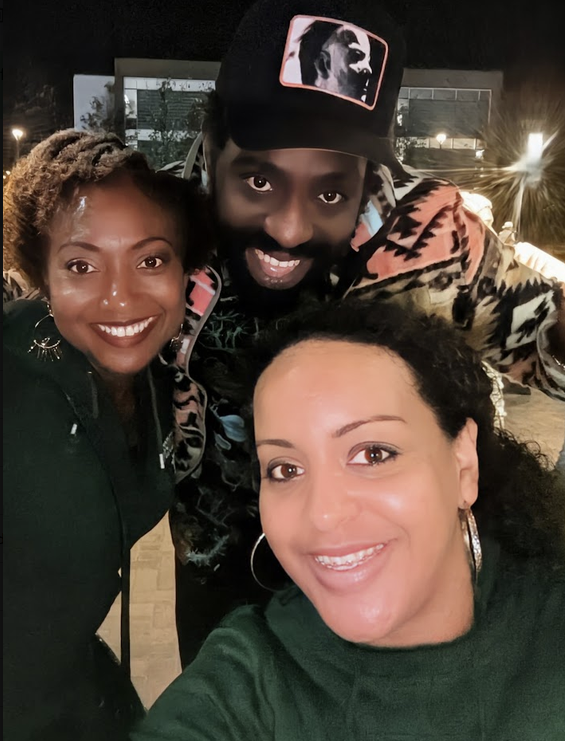 Tripoli taking an evening selfie with two friends