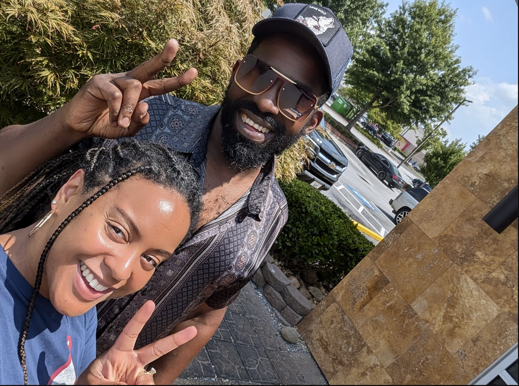 Tripoli and a friend giving peace signs on a sunny afternoon