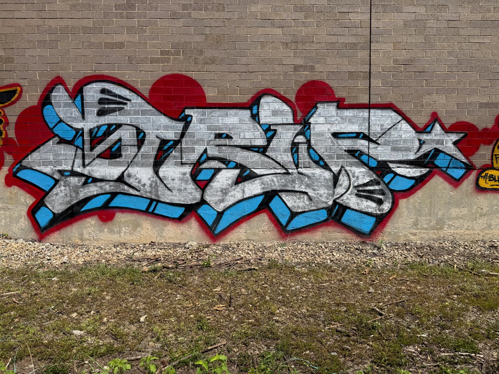 Graffiti tribute spelling TRIP on a brick wall