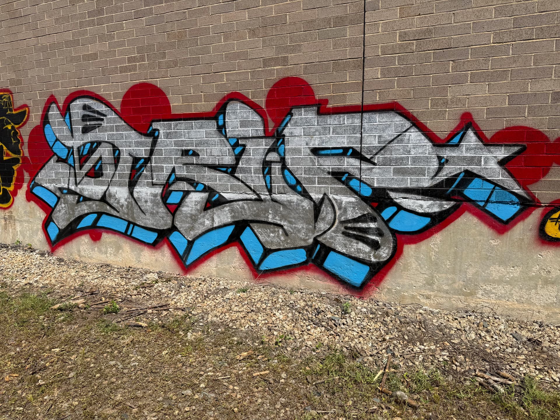 Graffiti tribute spelling TRIP on a brick wall